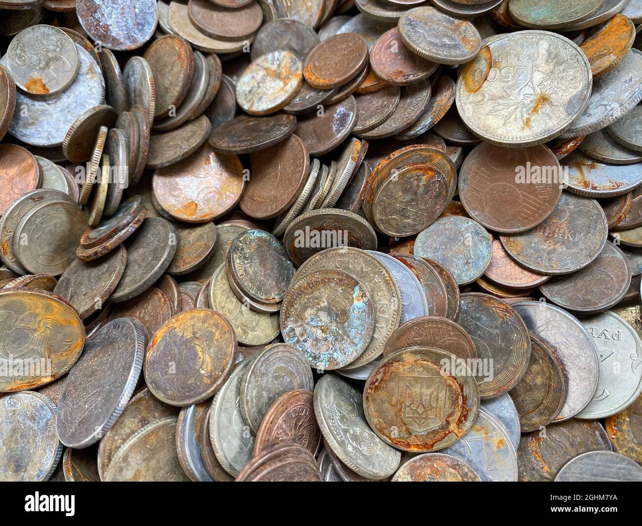 Top view composition of many weathered rusted coins of different ...