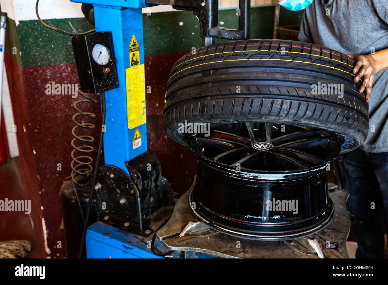 Fixing a wheel in repair shop Stock Photo Alamy