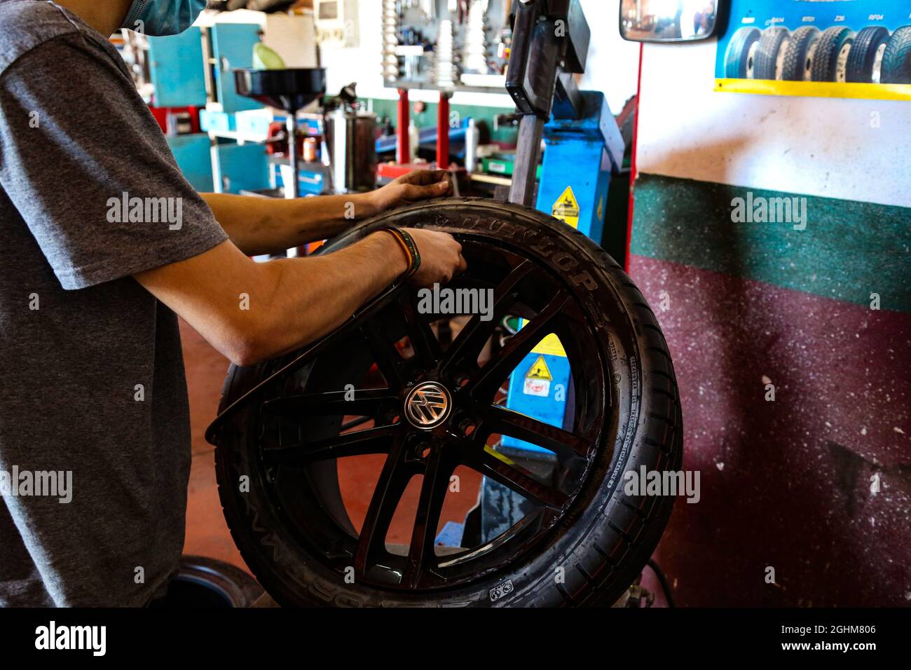 Fixing a wheel in repair shop Stock Photo Alamy