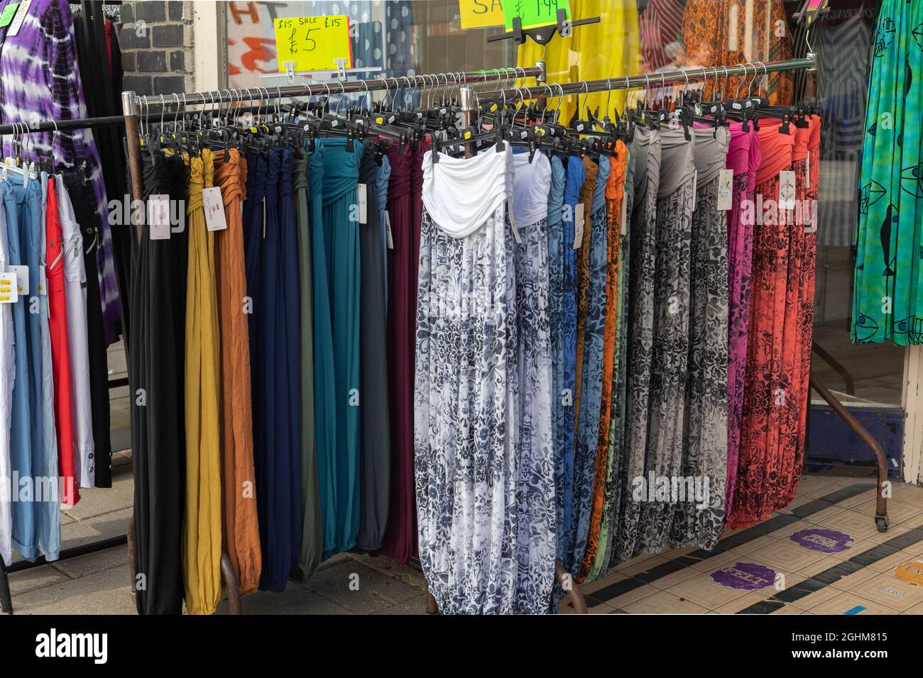 clothes rails featuring colourful trousers, in Worthing, West Sussex, UK, September, 2021 Stock Photo