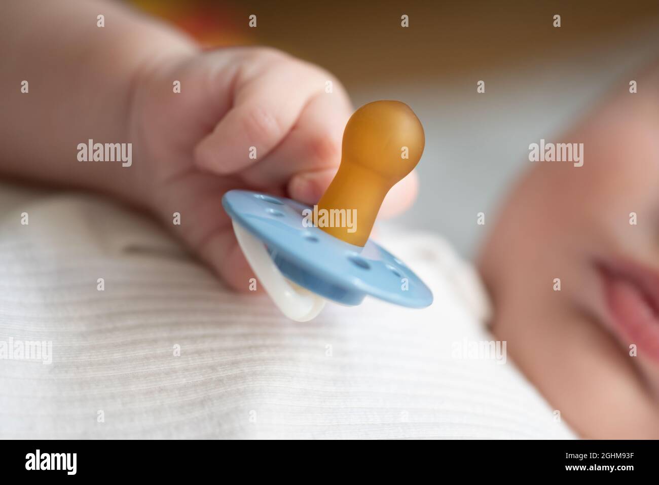 close-up view of hand of baby holding pacifier Stock Photo