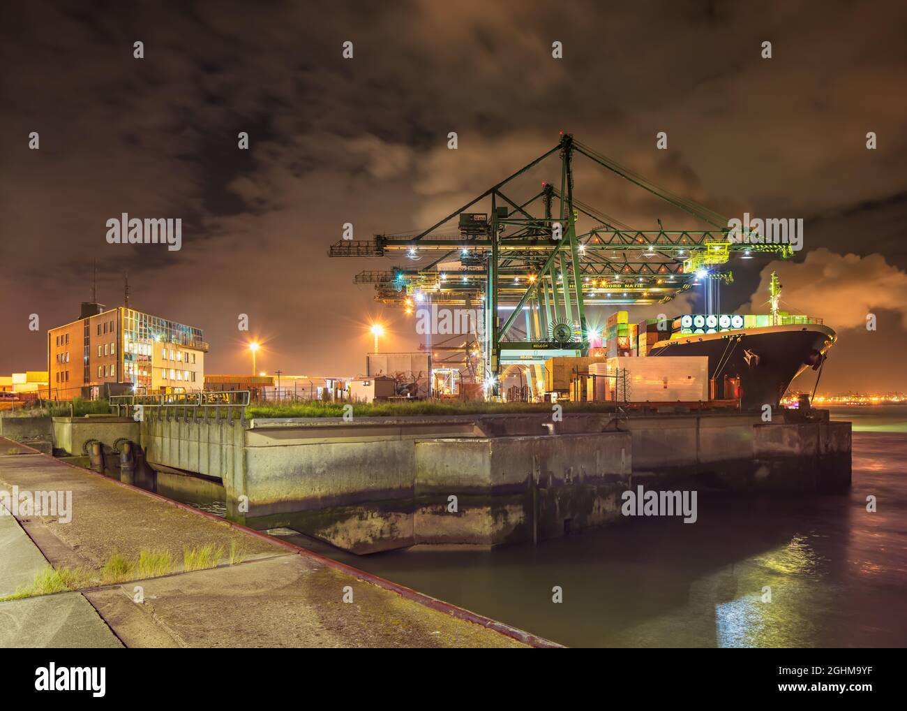 ANTWERP-AUGUST 27, 2021. Container terminal unloading a moored vessel ...