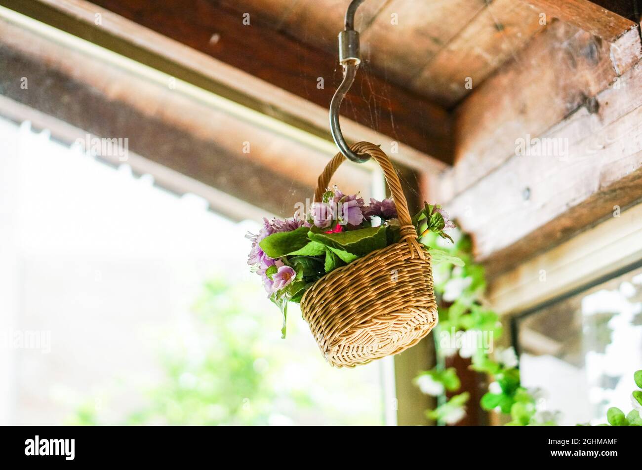 Fake flowers in a basket hanging on a dusty ceiling Stock Photo Alamy