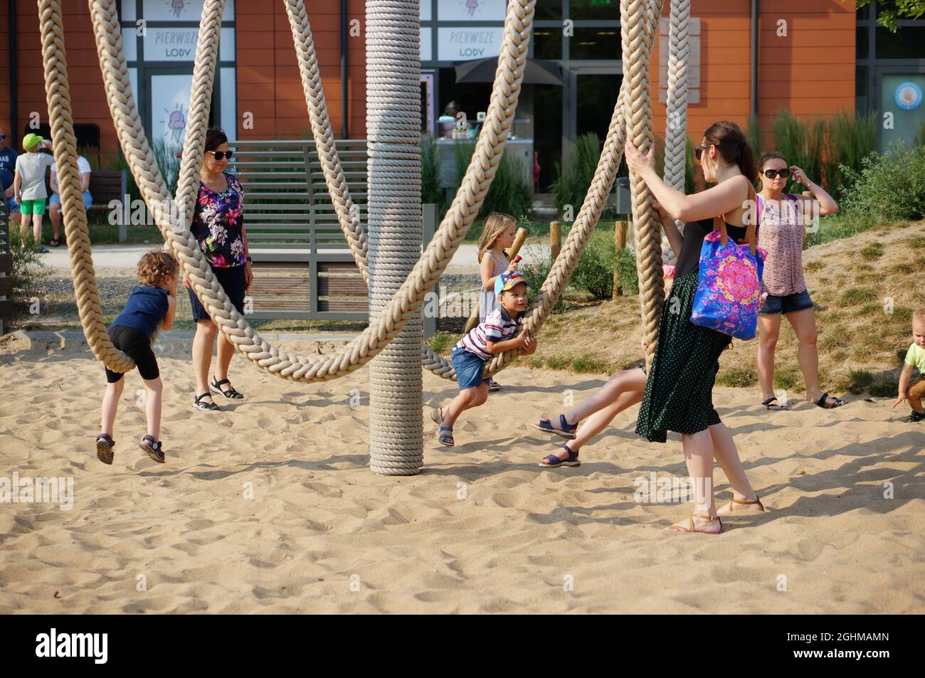 POZNAN, POLAND - May 31, 2018: A woman standing by her kids on rope ...