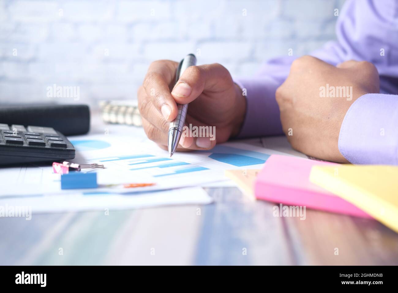 man hand with pen analyzing bar chart on paper Stock Photo - Alamy