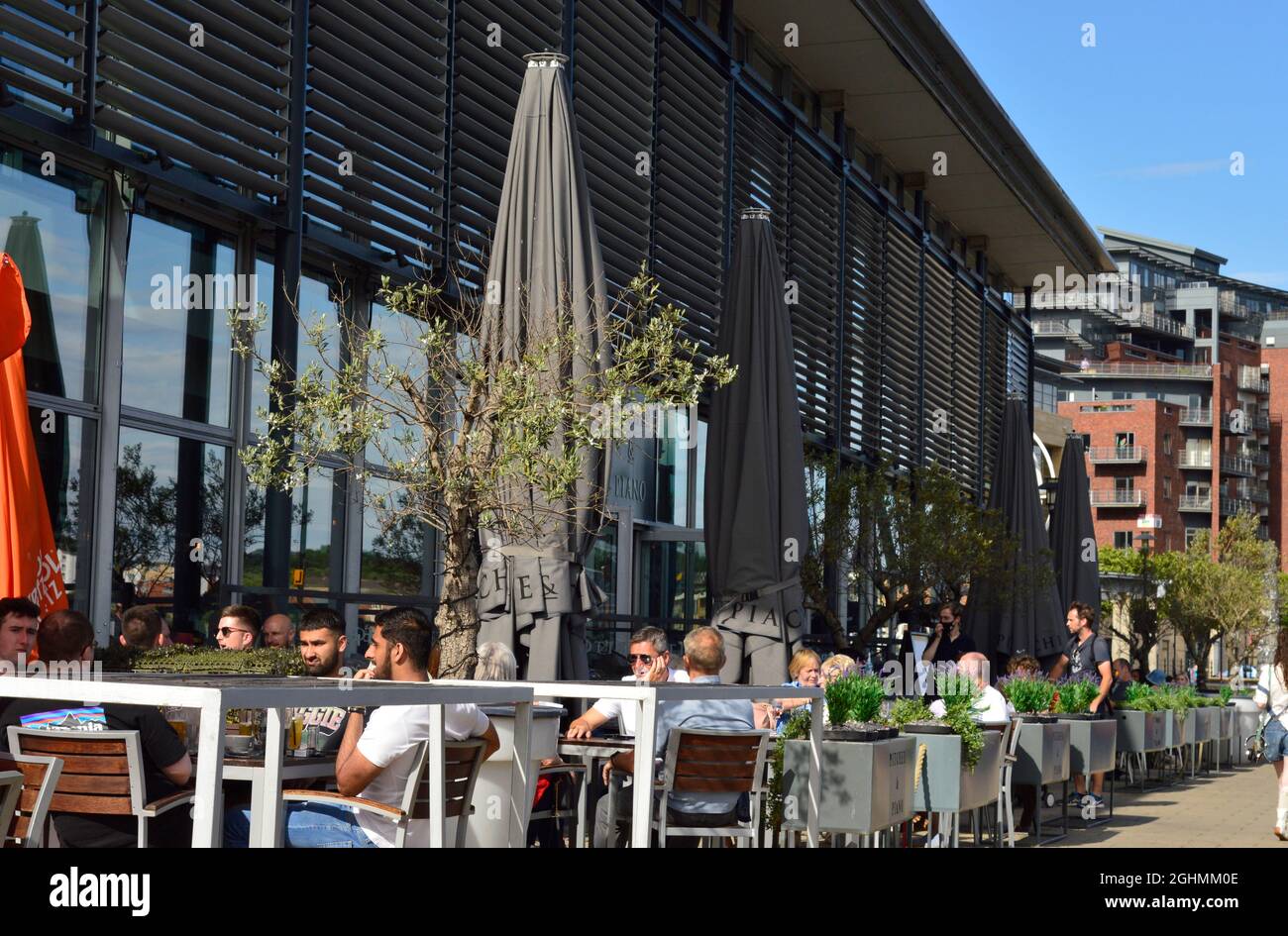 NEWCASTLE. TYNE and WEAR. ENGLAND. 06-24-21. The Quayside by the Tyne, customers sat outside a bar to help with social distancing regulations. Stock Photo