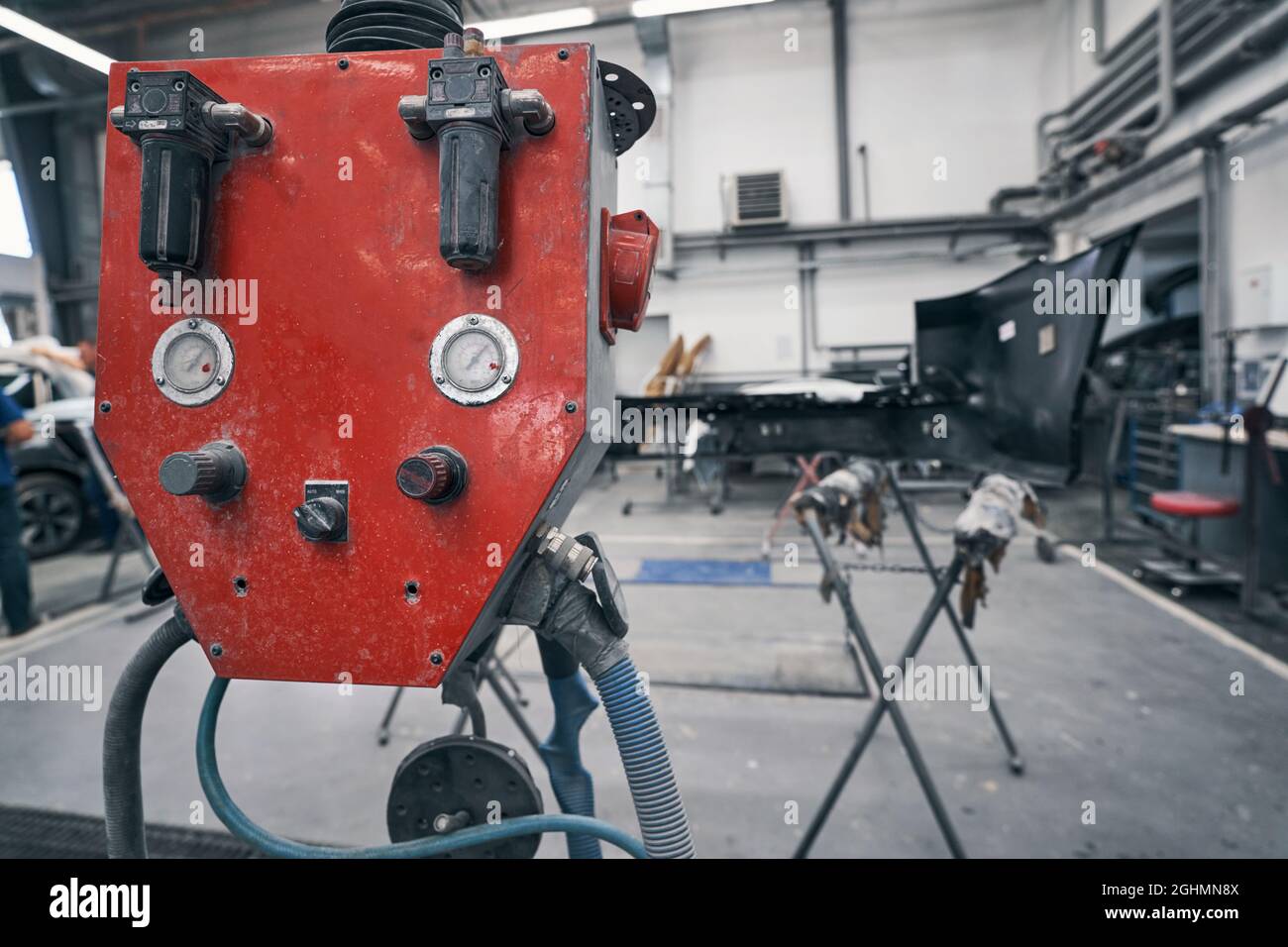 Compressed air distributor device standing in car repair Stock