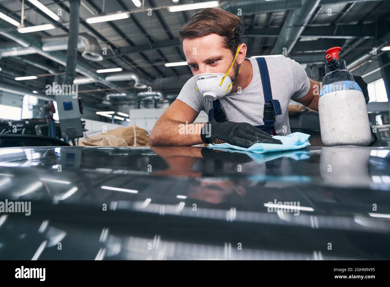 Worker checking an automobile surface after cleaning Stock Photo