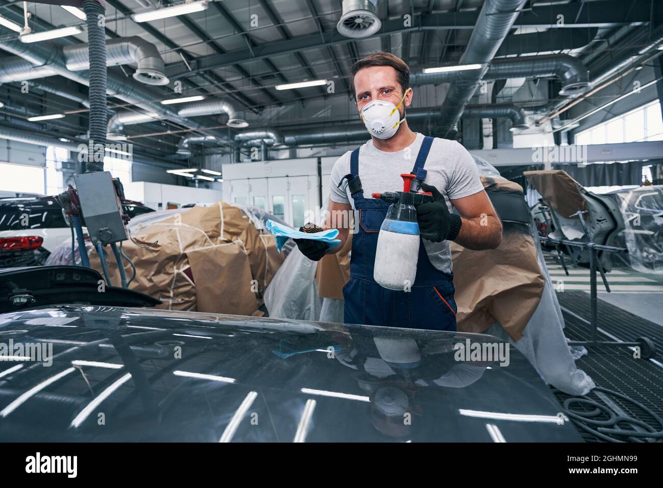Worker of auto repair garage preparing to clean car Stock Photo
