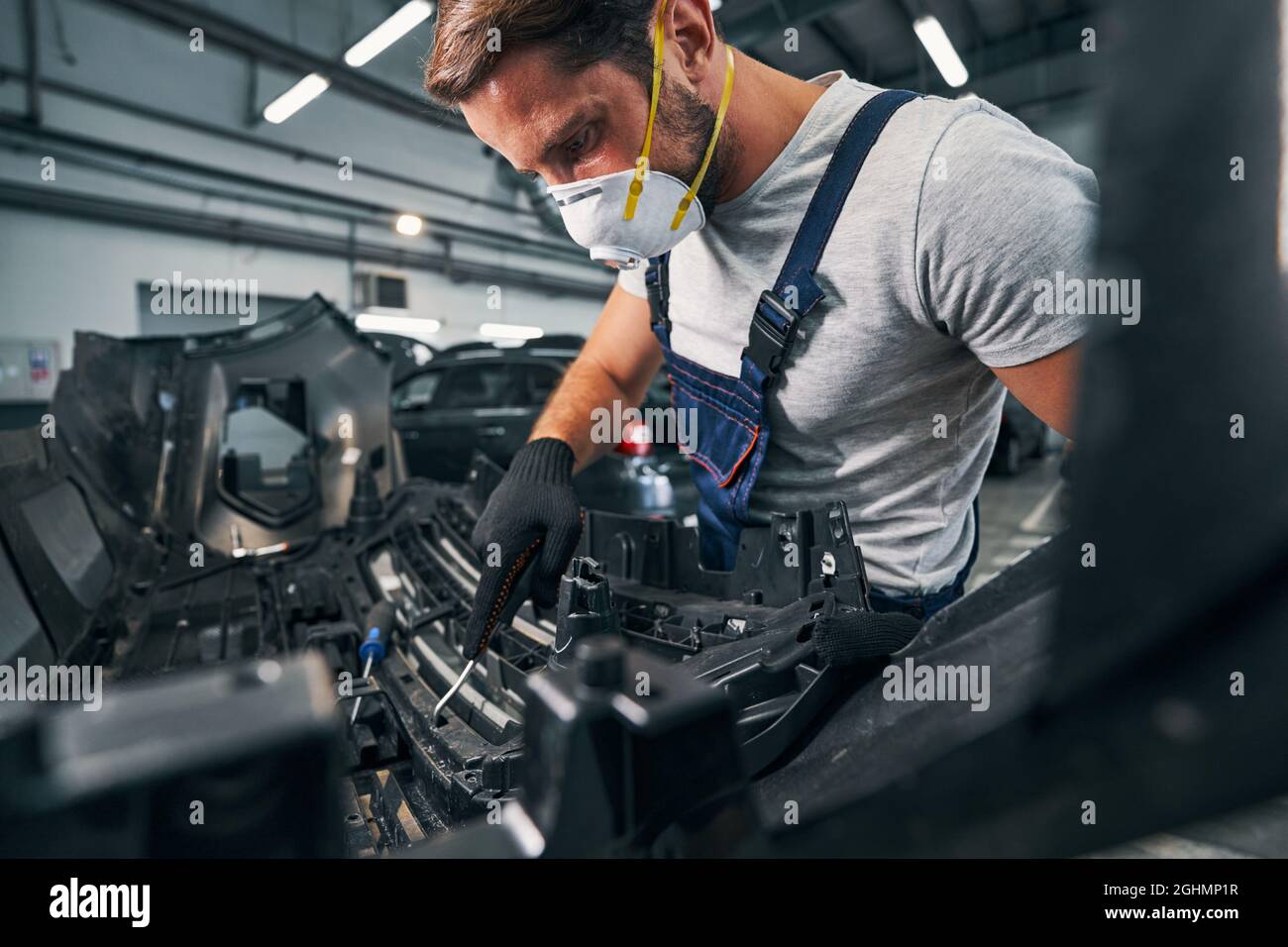 Repairman checking spare part condition with wrench Stock Photo
