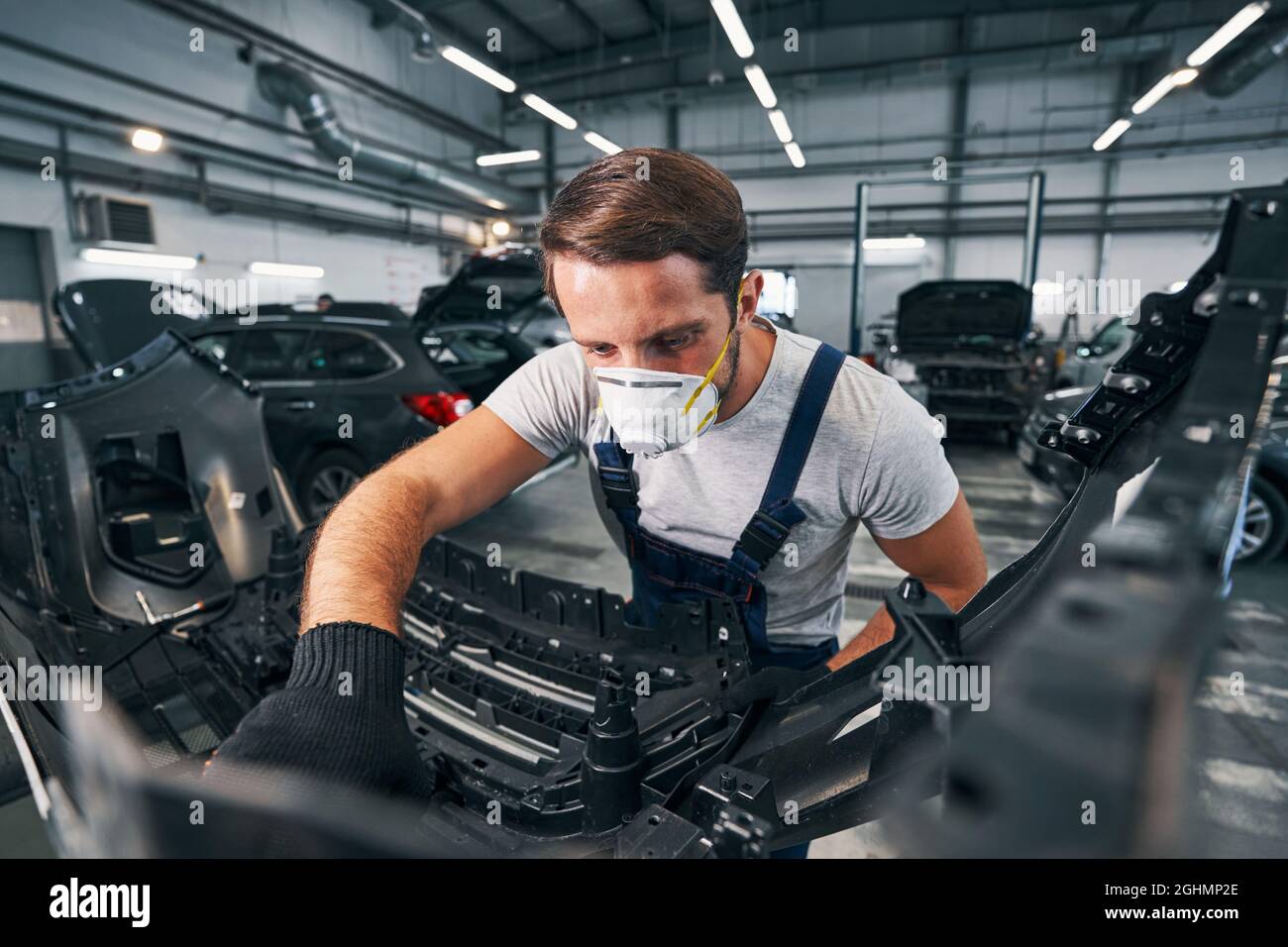 Automotive technician inspecting detail of a car Stock Photo