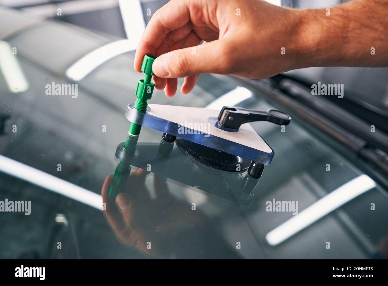 Person using bridge and injector kit for car window Stock Photo