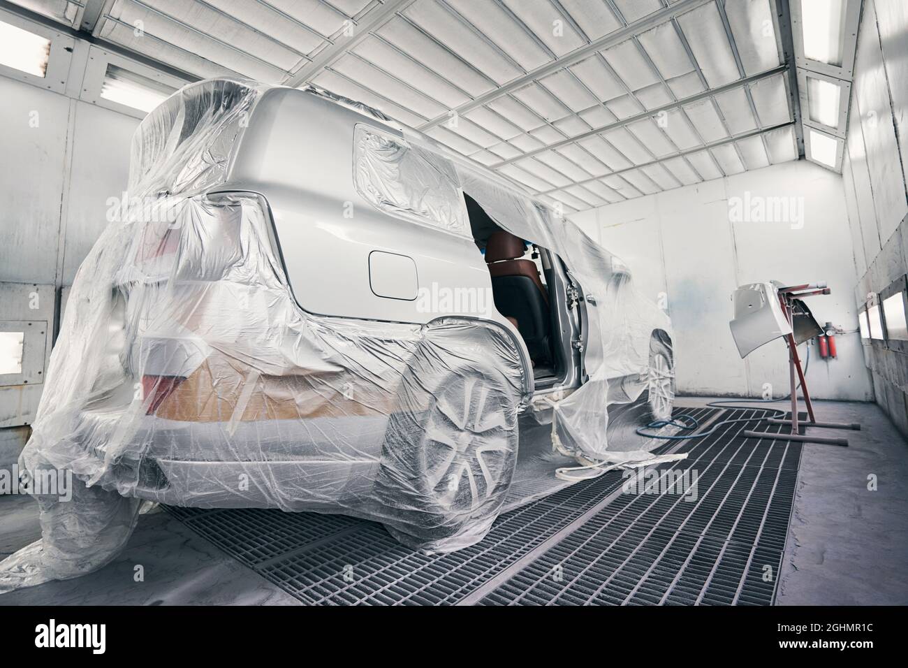 Car in a coating room ready for painting Stock Photo