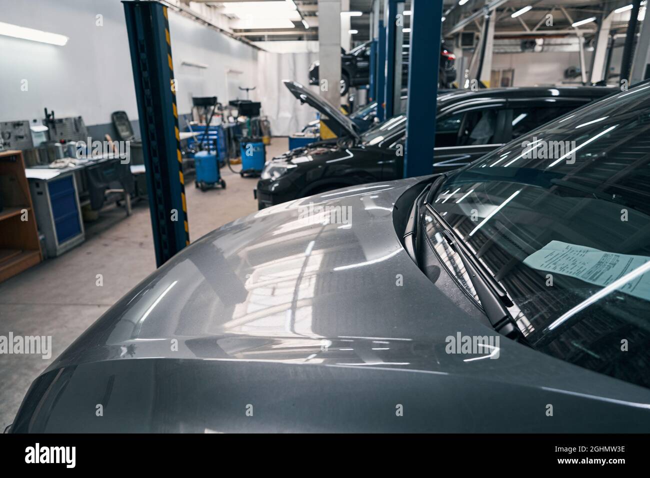 Cars standing one after another in auto services station Stock Photo