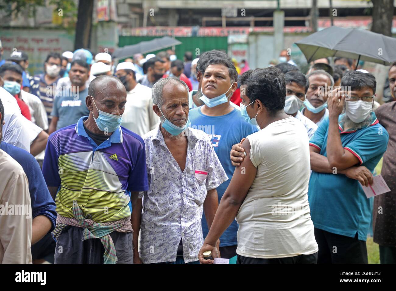 A Person receives The booster dose to avoid the risk of being infected  during  the Corona national mass vaccination campaign at Mohammadpur High School. The program started simultaneously across the country on Tuesday  at 9 am. On September 9, 2021 in Dhaka, Bangladesh. (Photo by Maruf Rahman  / Eyepix Group) Stock Photo