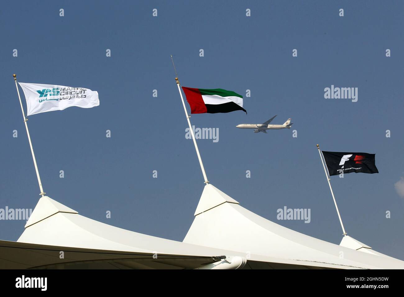 Etihad plane flies past the grandstand flags. 07.11.2012. Formula 1 Young Drivers Test, Day 2, Yas Marina Circuit, Abu Dhabi, UAE.  Stock Photo
