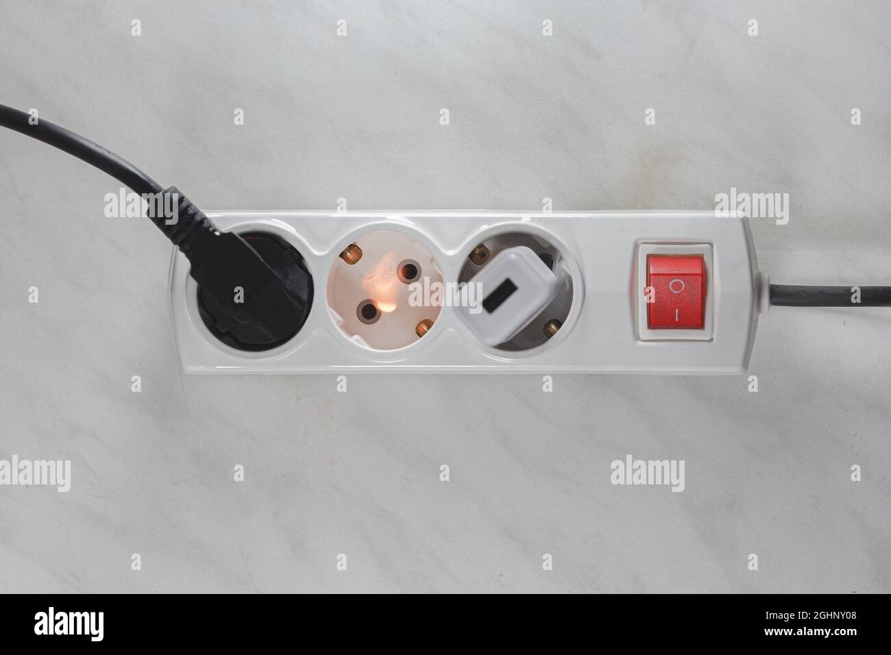 Ignited plug in the power supply board - short circuit of the wiring Stock Photo