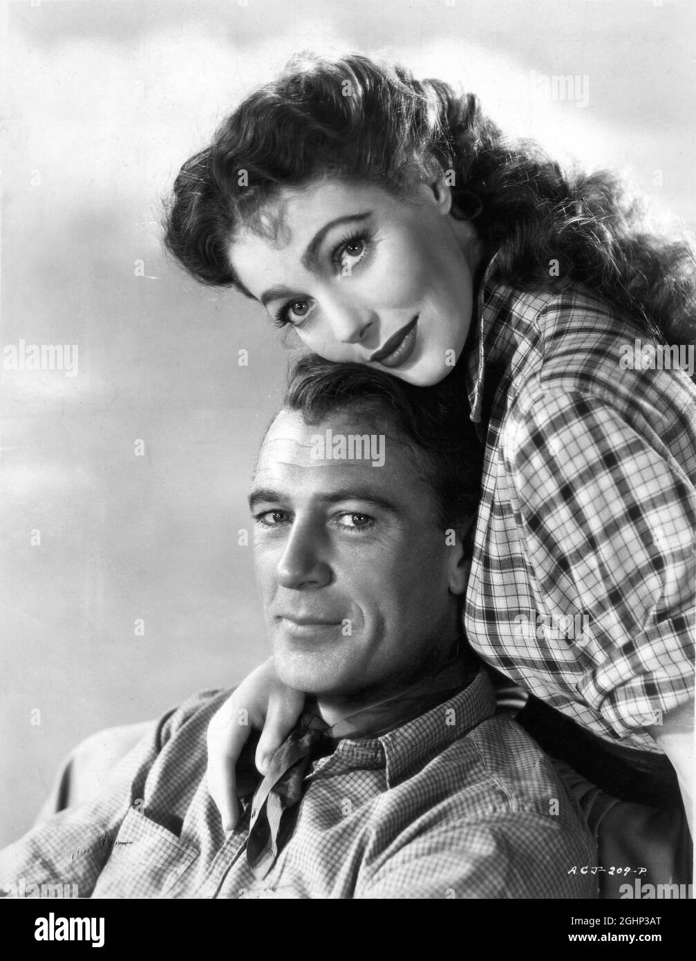 GARY COOPER and LORETTA YOUNG Publicity Portrait in ALONG CAME JONES 1945 director STUART HEISLER novel Useless Cowboy by Alan Le May screenplay Nunnally Johnson costume design Walter Plunkett producer Gary Cooper International Pictures / RKO Radio Pictures Stock Photo