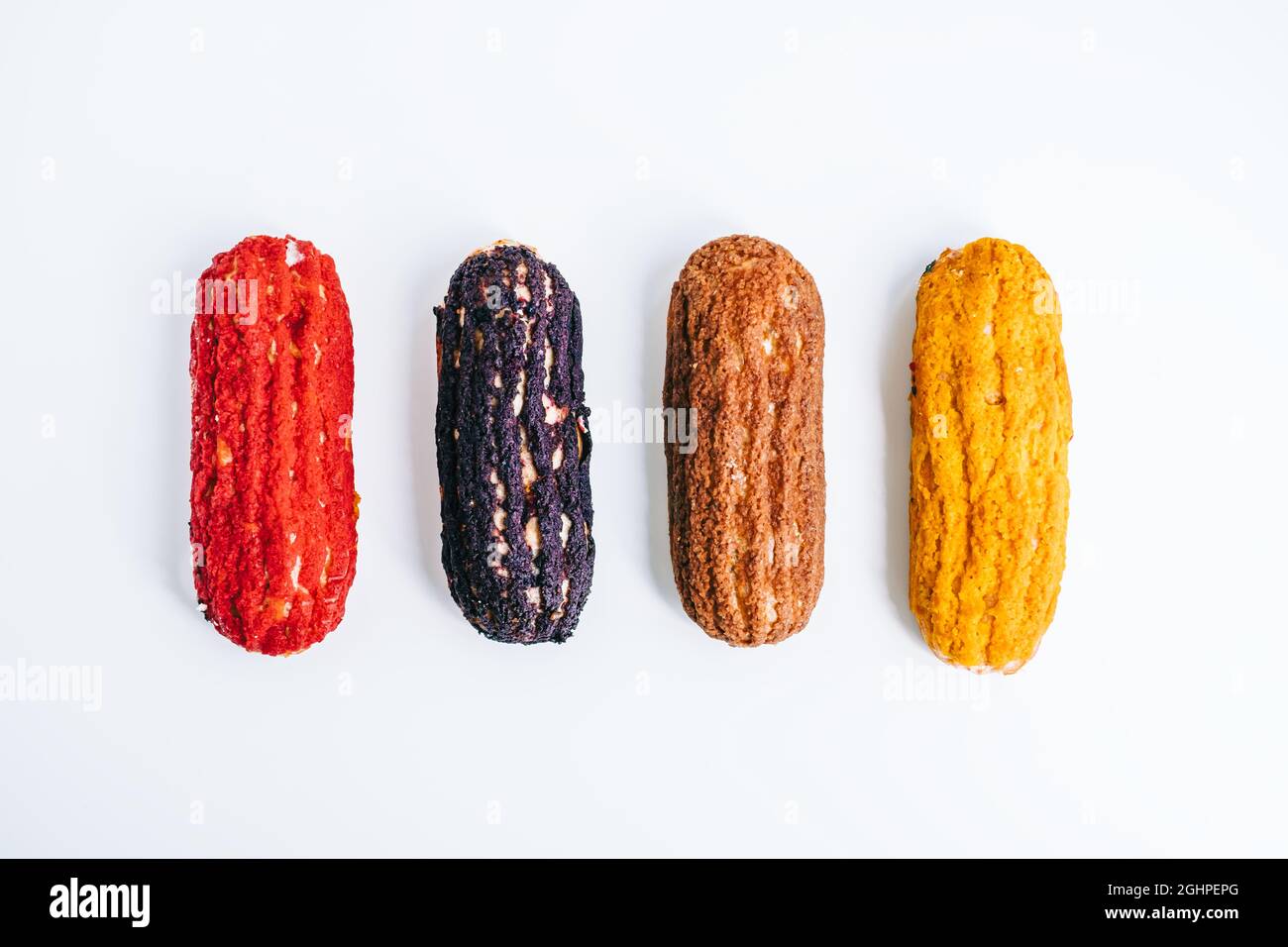 Multicolored eclairs isolated on white background. Stock Photo
