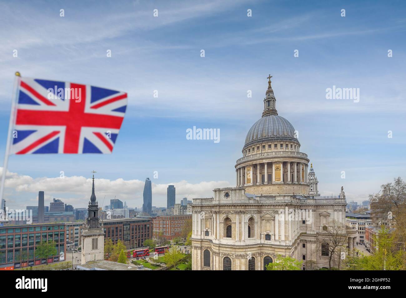 London, England - Sep. 7, 2021 - A Union Jack flag flies in the wind with a view of St Paul's Cathedral in the background. Stock Photo
