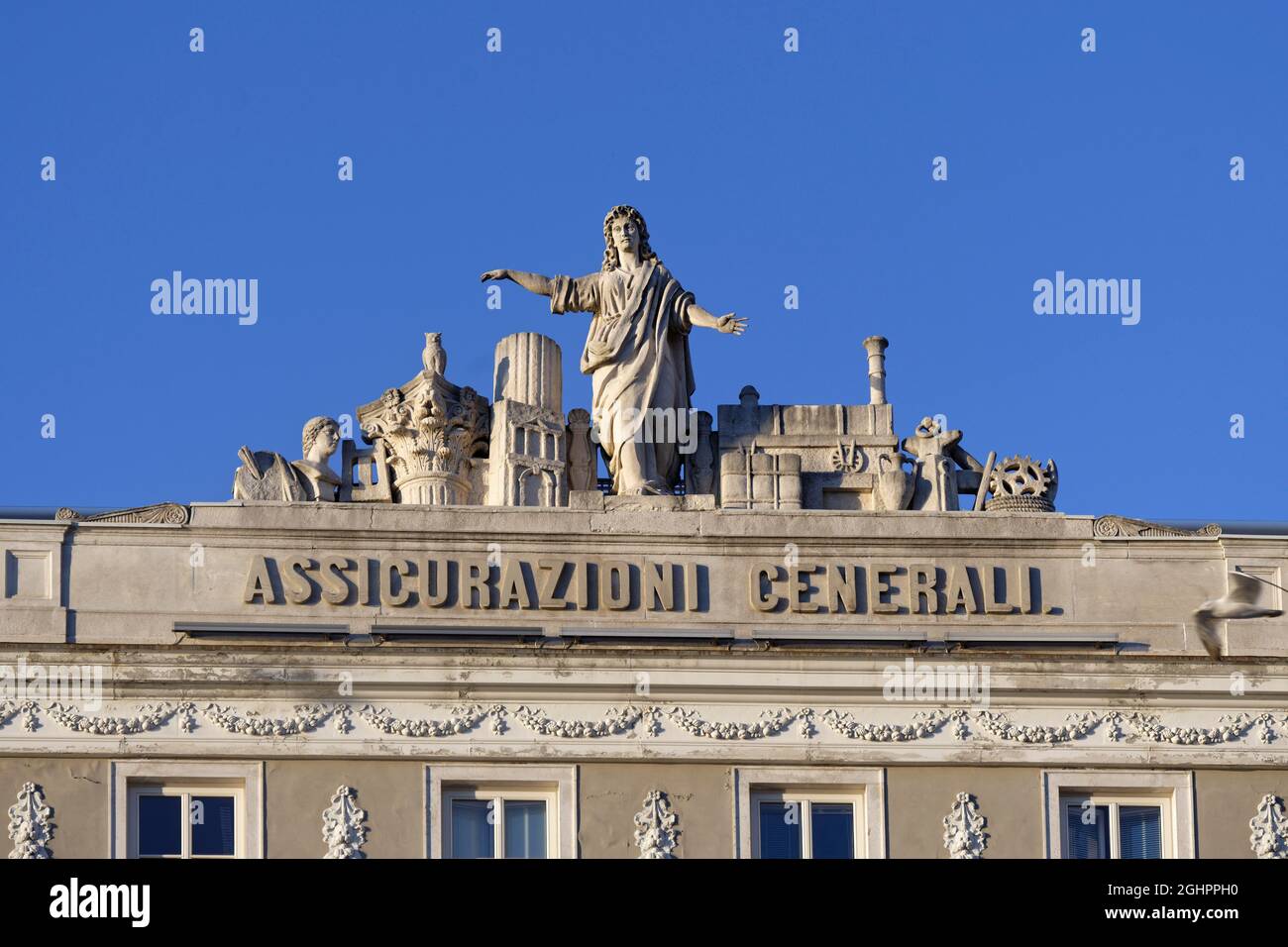 Piazza Unita d'Italia, Casa Stratti, Generali Insurance, facade with statues on the roof, Old Town, Trieste, Friuli Venezia Giulia, Italy Stock Photo