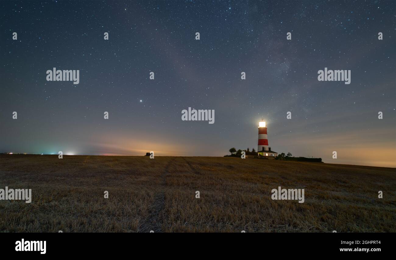 A night-time image of Happisburgh Lighthouse (Norfolk) with the Milky Way showing Stock Photo