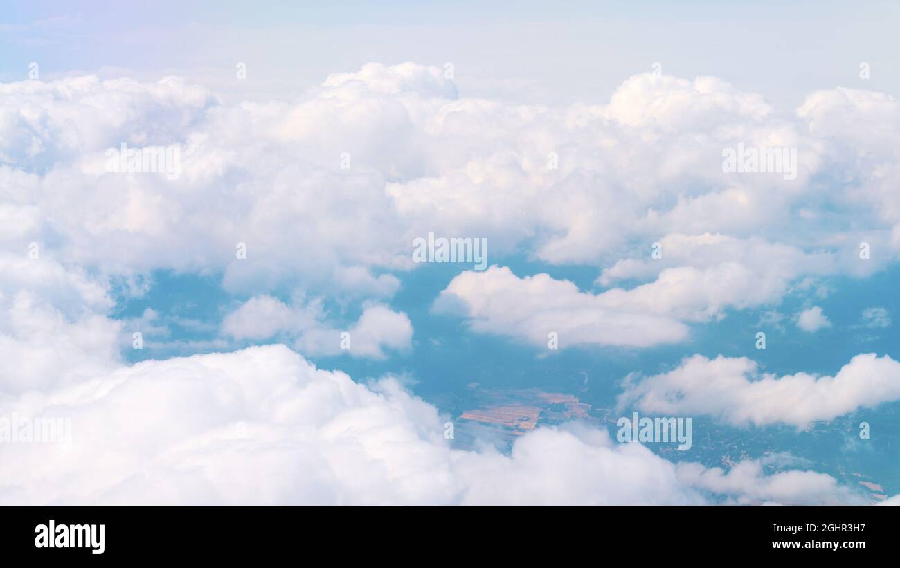 Aerial view of breathtaking fluffy clouds as white as snow in the blue ...
