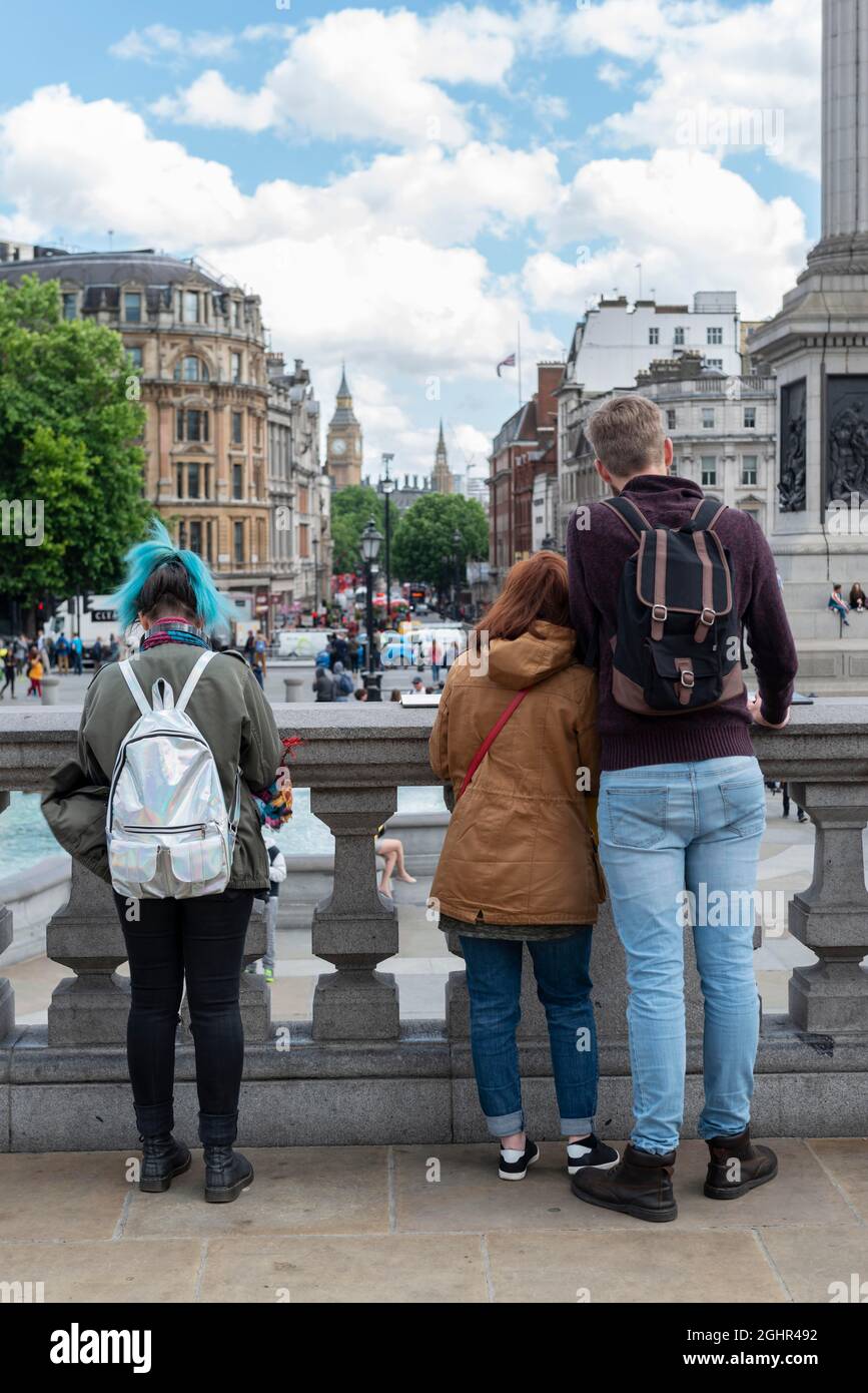 Young people standing in Trafalgar Square, Big Ben behind, London, England, United Kingdom Stock Photo