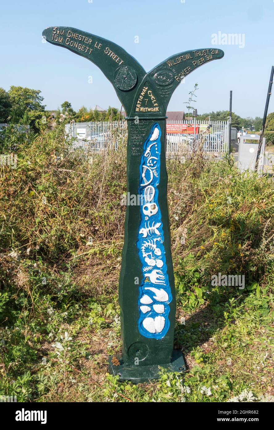 A Sustrans millennium milepost, designed by Jon Mills, on the coast to coast cycle route in Washington, Tyne and Wear, England, UK Stock Photo