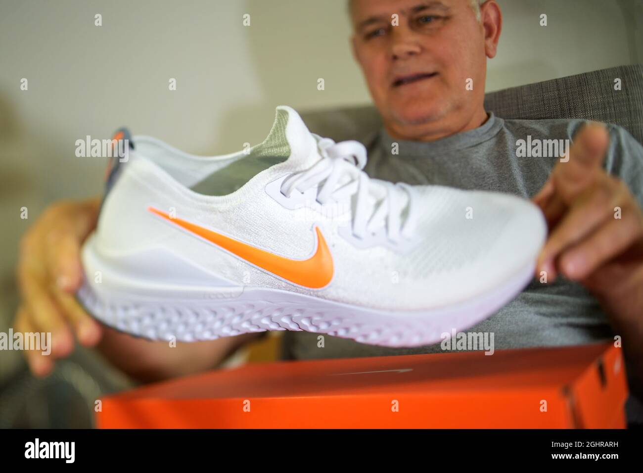senior man admiring new Nike Epic React flyknit running sport shoe Stock  Photo - Alamy