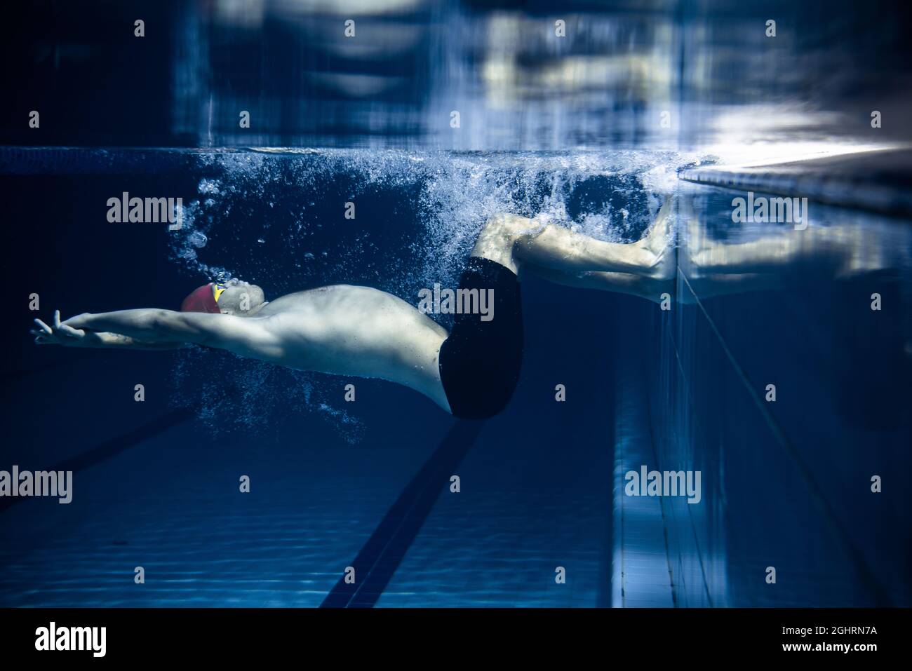 One Male Swimmer Practicing And Training At Pool Indoors Underwater