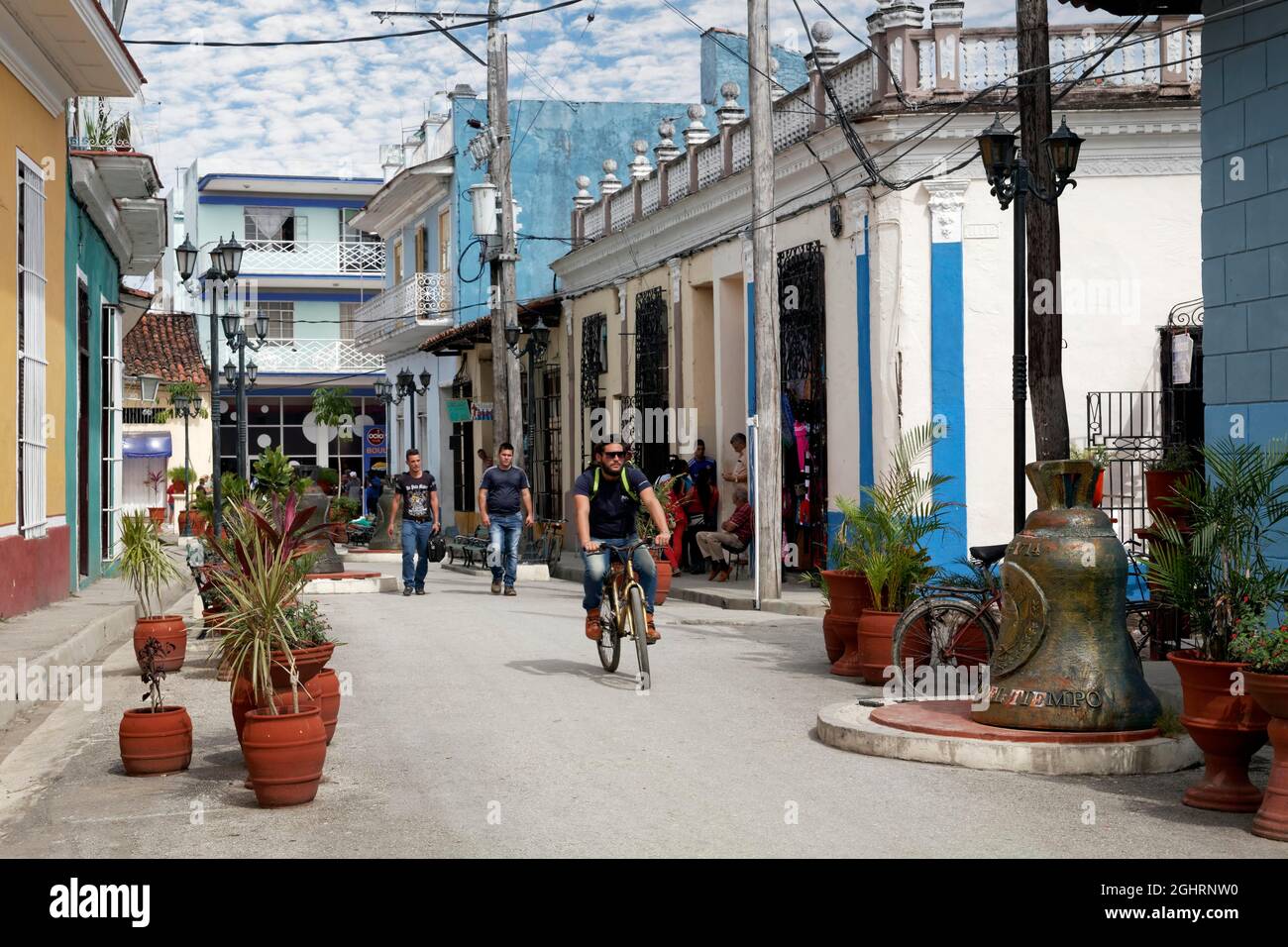 Street Scene, Caribbean, People, Cubans, Cyclists and Church Bells in the Street of the Bell, Calle Honorato, Old Town, Sancti Spiritus, Central Stock Photo