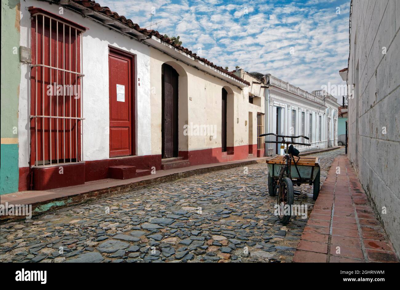 Street scene, old cobblestones, houses from Spanish colonial times, cargo bike, Sancti Spiritus, Central Cuba, Sancti Spiritus Province, Caribbean Stock Photo