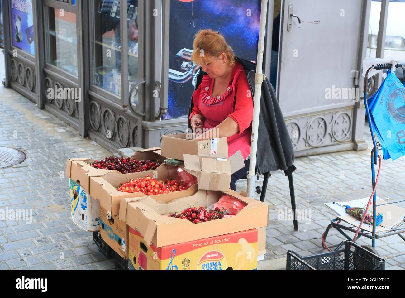 Vendor of cherries in front of Privoz food market, Odessa, Ukraine Stock Photo