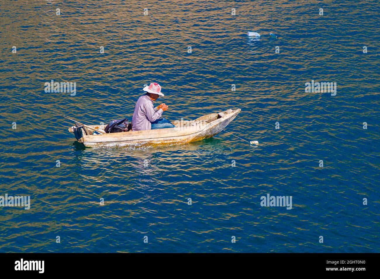 Fisherman in his floating coffin, Eupithecia (Catarina) Palopo, Lake Atitlan, Santa Catarina Palopo, Guatemala Stock Photo
