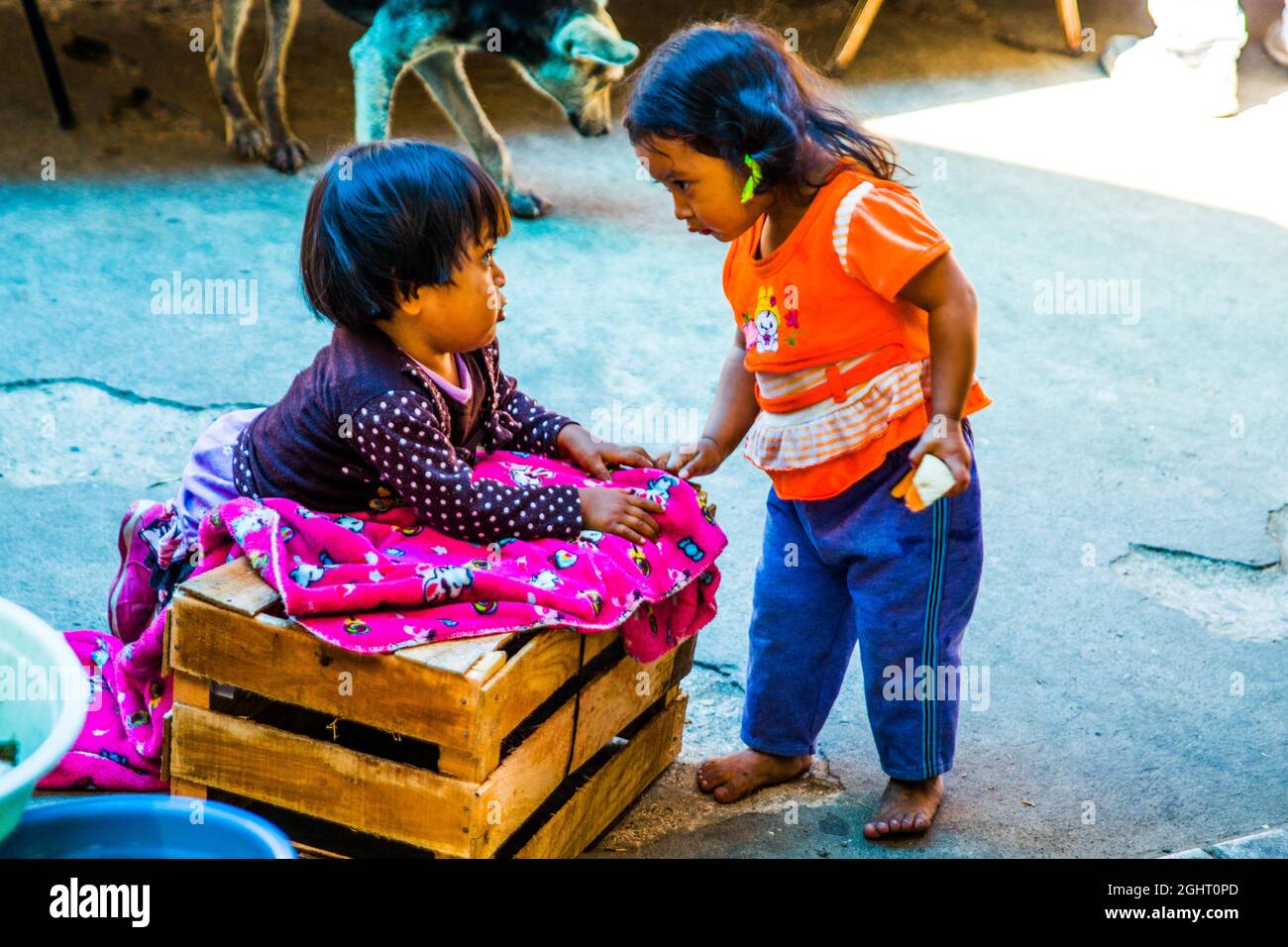Children playing at the market, San Juan La Laguna, Lake Atitlan, San Juan La Laguna, Guatemala Stock Photo