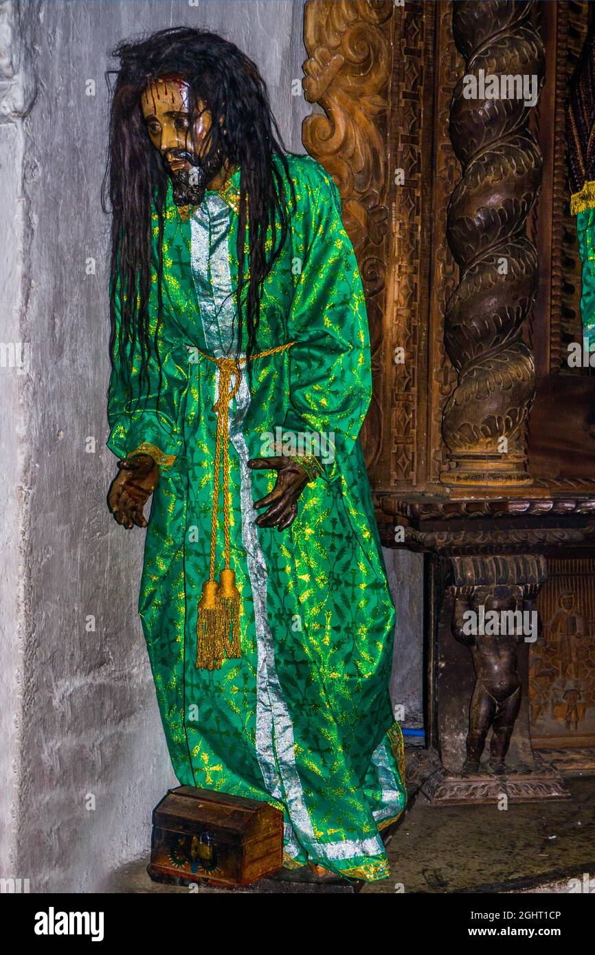Wooden figure of Jesus with real hair, dressed in traditional traditional costume, colonial-era Iglesia Parroquial Santiago Apostol from 1566 Stock Photo