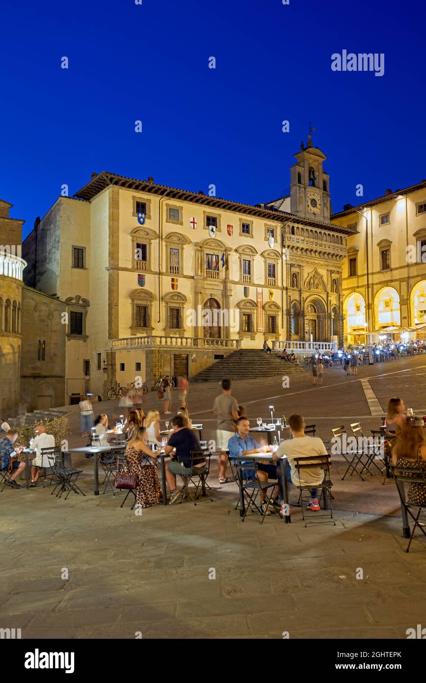 Arezzo Tuscany Italy. Piazza Grande at sunset. People eating out Stock Photo
