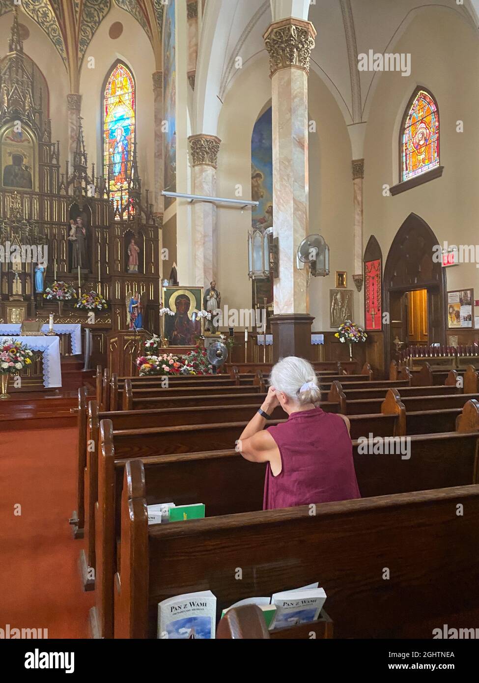 Woman deep in prayer at a Catholic Curch in Sunset Park, Brooklyn, New York. Stock Photo