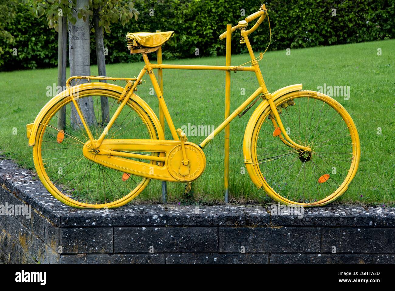 Closeup on a yellow bicycle on a lawn Stock Photo
