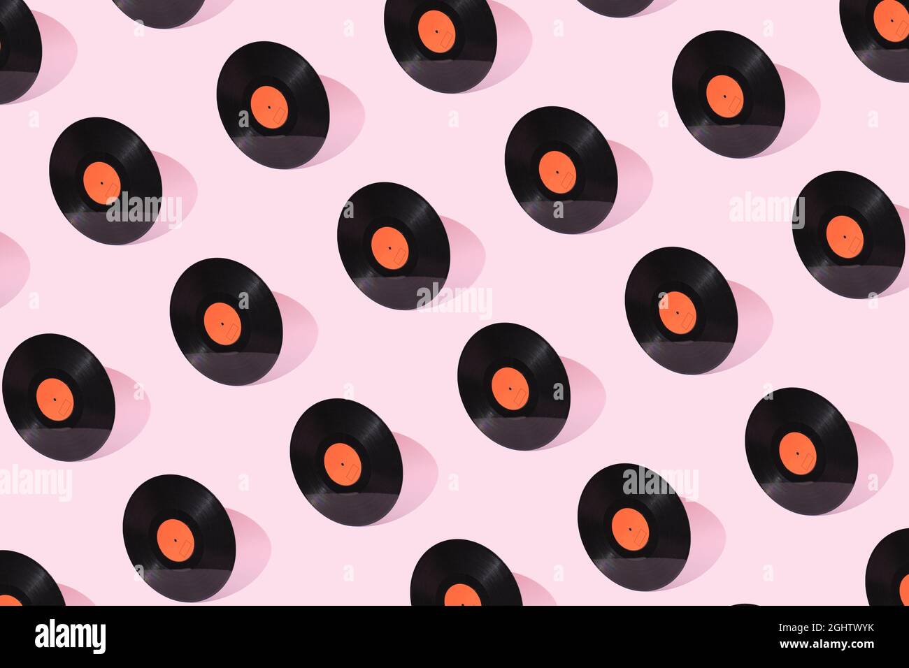 Retro Music Pattern Black old vinyl record with orange clean label isolated on pastel pink ...
