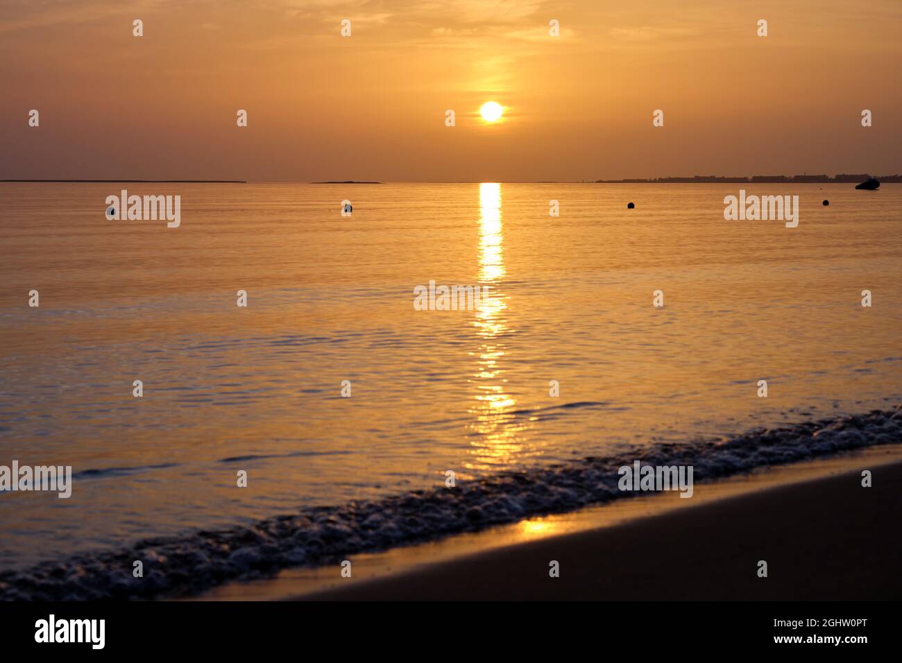 Calm sea shore with crushing waves on sandy beach at sunrise Stock ...