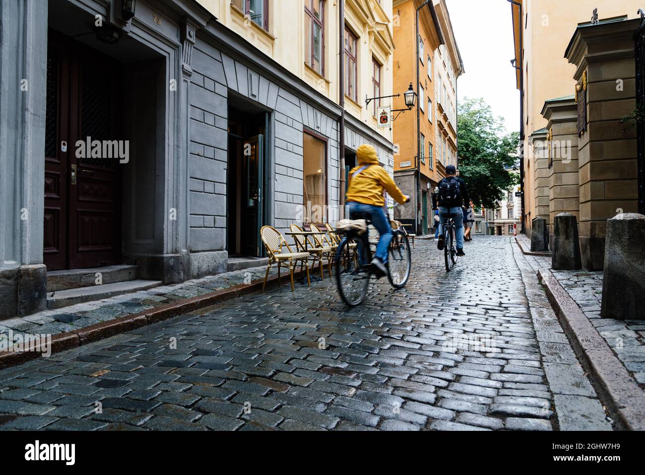 Stockholm, Sweden - August 8, 2019: Tourists riding bicycles in cobblestoned street in Gamla Stan. The Old Town is one of the largest and best preserv Stock Photo