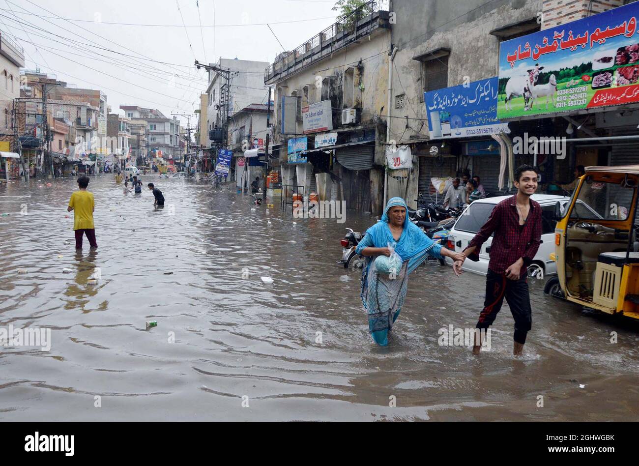 Commuters are facing difficulties in transportation due to stagnant rainwater causing of poor sewerage system during heavy downpour of monsoon season, at Dhoke Farman Ali area of Rawalpindi on Tuesday, September 07, 2021. Stock Photo