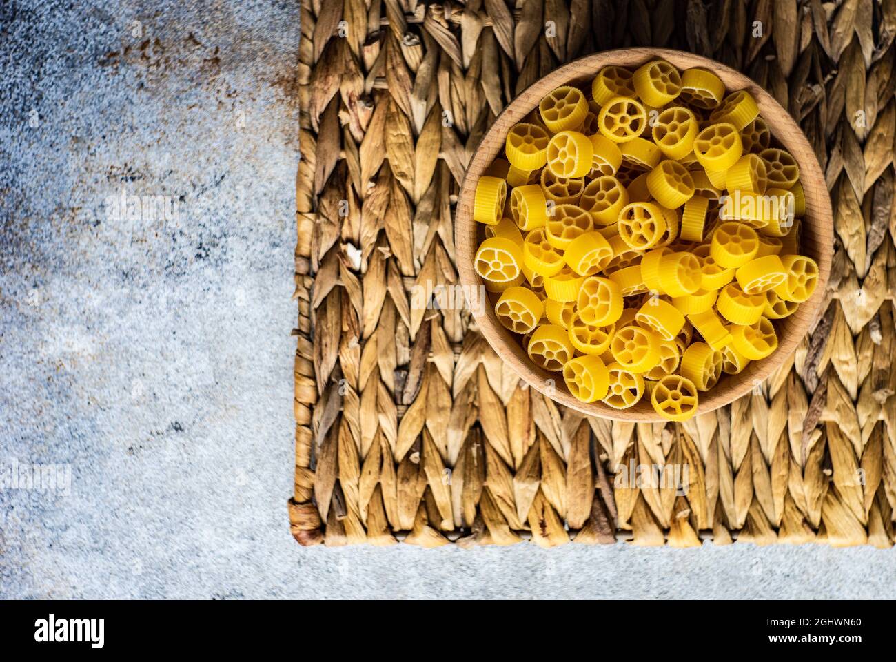 Overhead view of a bowl of ruote pasta on a place mat Stock Photo