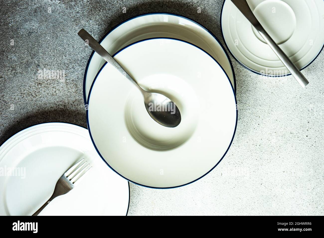 Minimalistic table setting with plate and cutlery Stock Photo