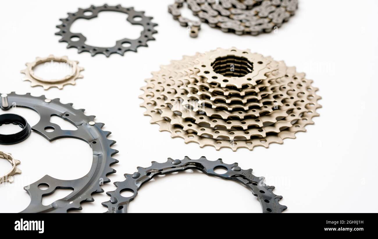 Gears, sprockets and chain of a mountain sports bike on a white