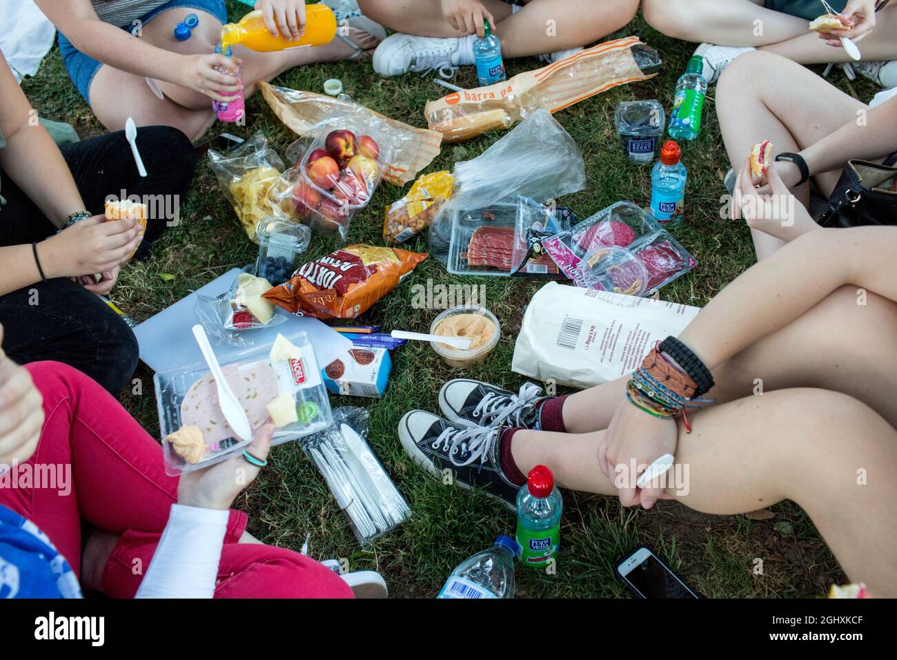 Barcelona, Spain, July 2018. People enjoy a picnic in a park in