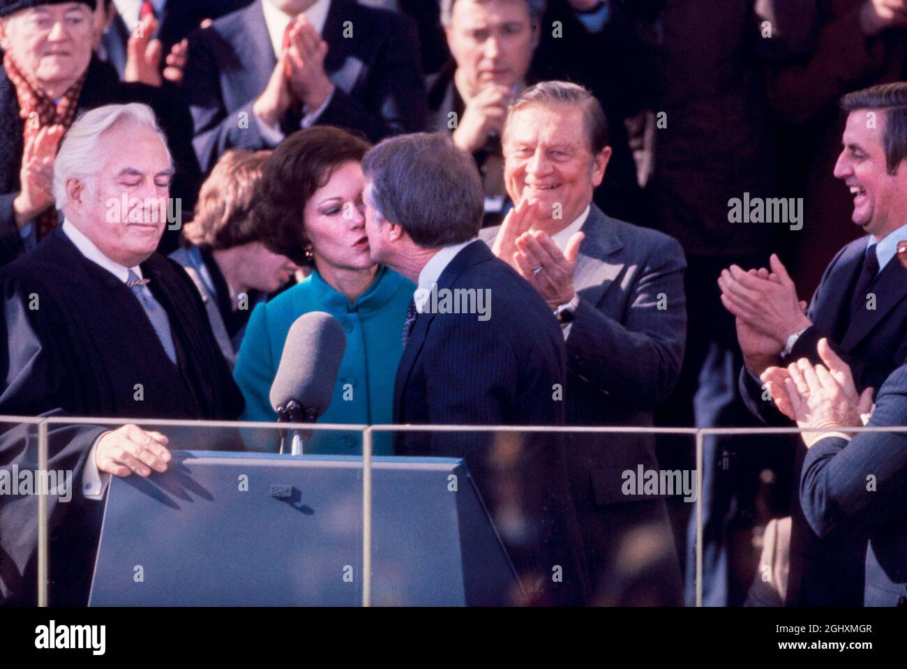 U.S. President Jimmy Carter kissing wife Rosalynn Carter after taking oath of office of President of the United States from, East Portico of U.S. Capitol, Washington, D.C., USA, Bernard Gotfryd, January 20, 1977 Stock Photo