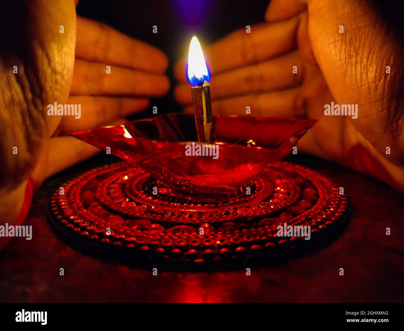 Person holding a clay oil lamp in the dark during the festival of lights at Bangalore, India Stock Photo